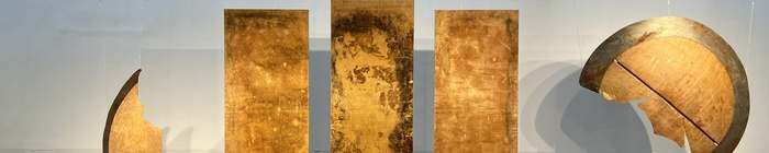 Installation view: rust and gold Kevlar panels by Coby Kennedy hanging in the L'SPACE Gallery.